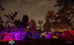 campground at ace adventure resort under the starts with tents lit up during moutain music festival 2017