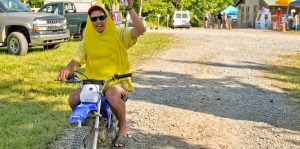 A festival camper rides his minibike through the mountaintop campground in a banana costume at Mountain Music Festival at ACE Adventure Resort in West Virginia.