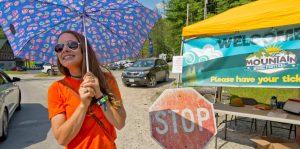 A volunteer staff member checks fans into the front gate for Mountain Music Festival at ACE Adventure Resort in Wet Virginia.