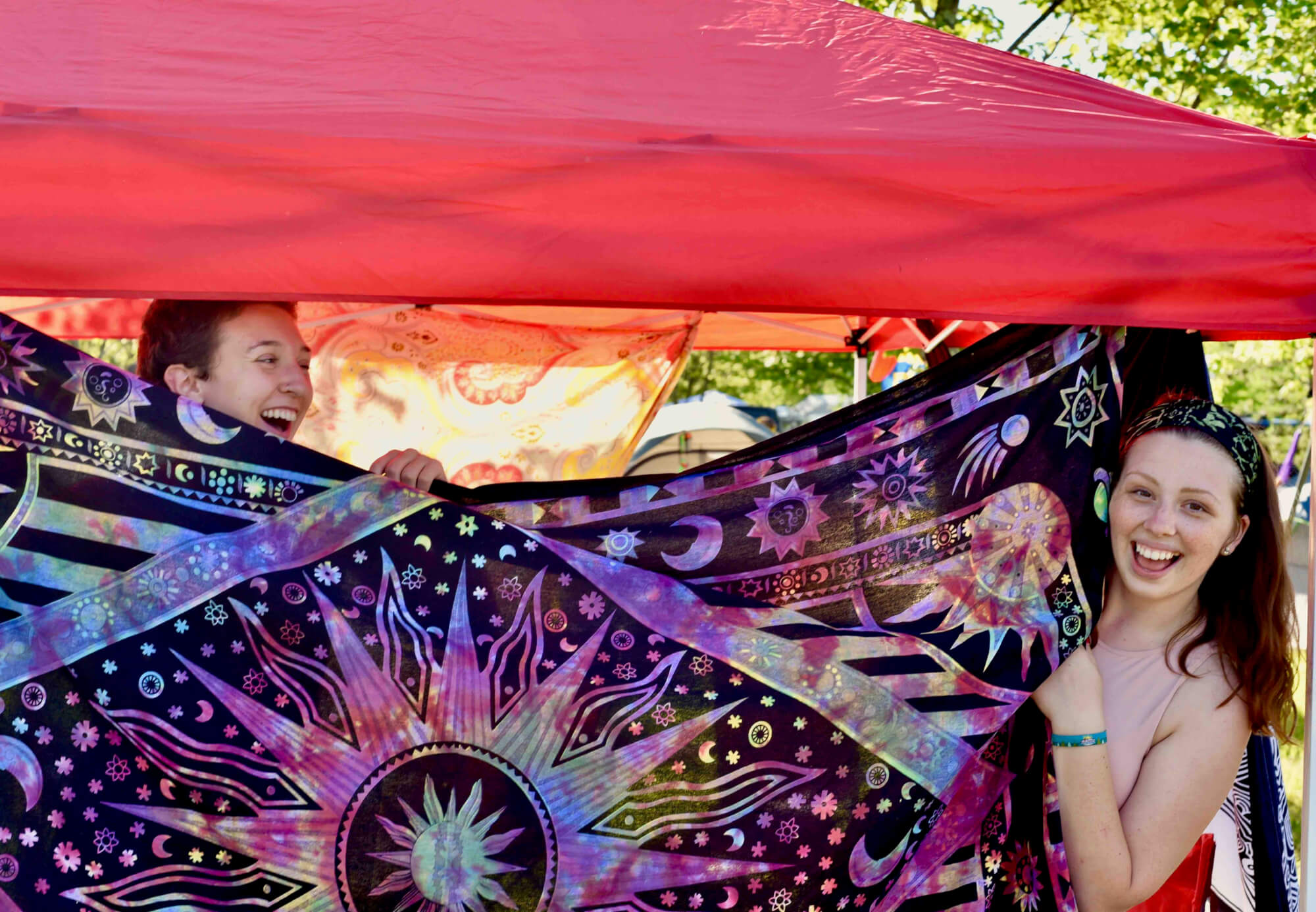 girls playing with tapestry in campground at mountain music festival at ace adventure resort 