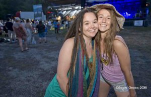 nina and girlfriend haning out in front of mountaintop main stage at mountain music festival 2018 all smiles