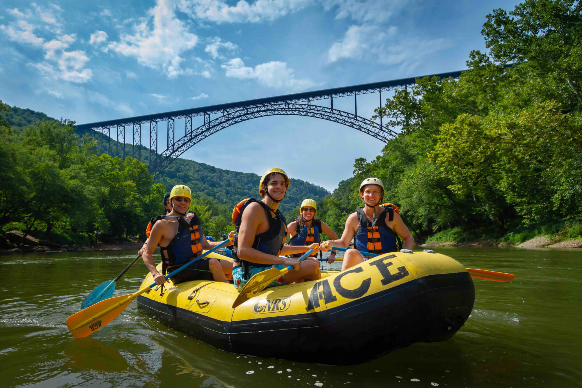 raft with happy family on the new river below the new river gorge bridge