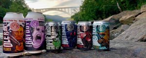 greenbrier valley brewing company beer cans on the new river with bridge in background devil anse ipa