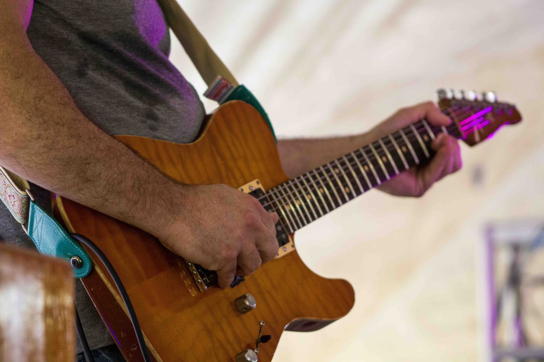 musician playing guitar at mountain music festival strange stage 2019