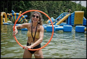 girl with hula hoop dancing on the beach at wonderland waterpark at ace adventure resort during mountain music festival