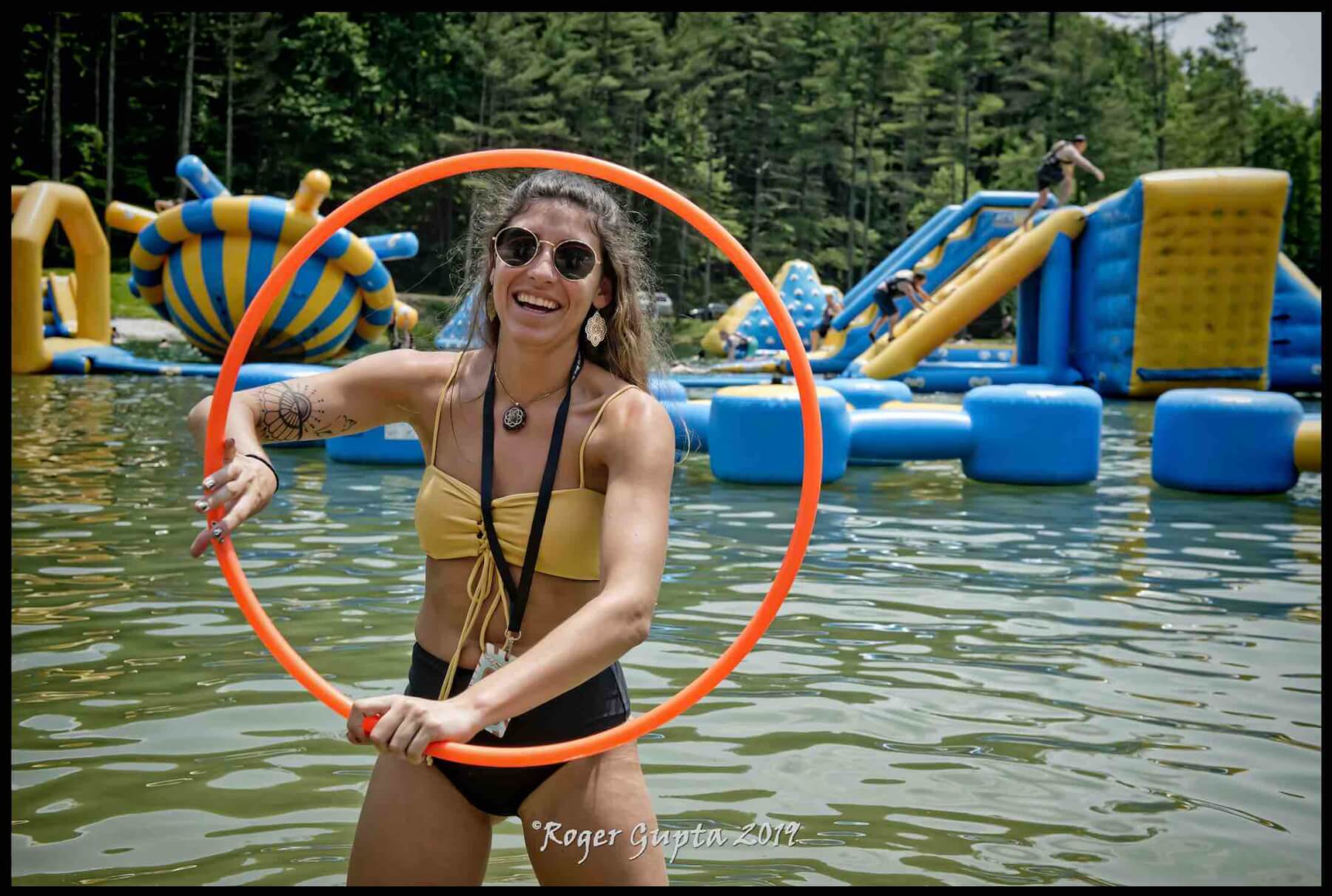 girl with hula hoop dancing on the beach at wonderland waterpark at ace adventure resort during mountain music festival