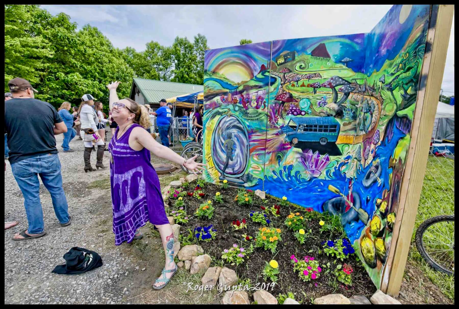 happy fan at mountain music festival with visual artist mural 