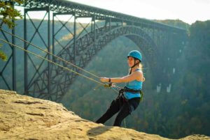 climbing and rappeling at bridge buttress in the new river gorge with bridge