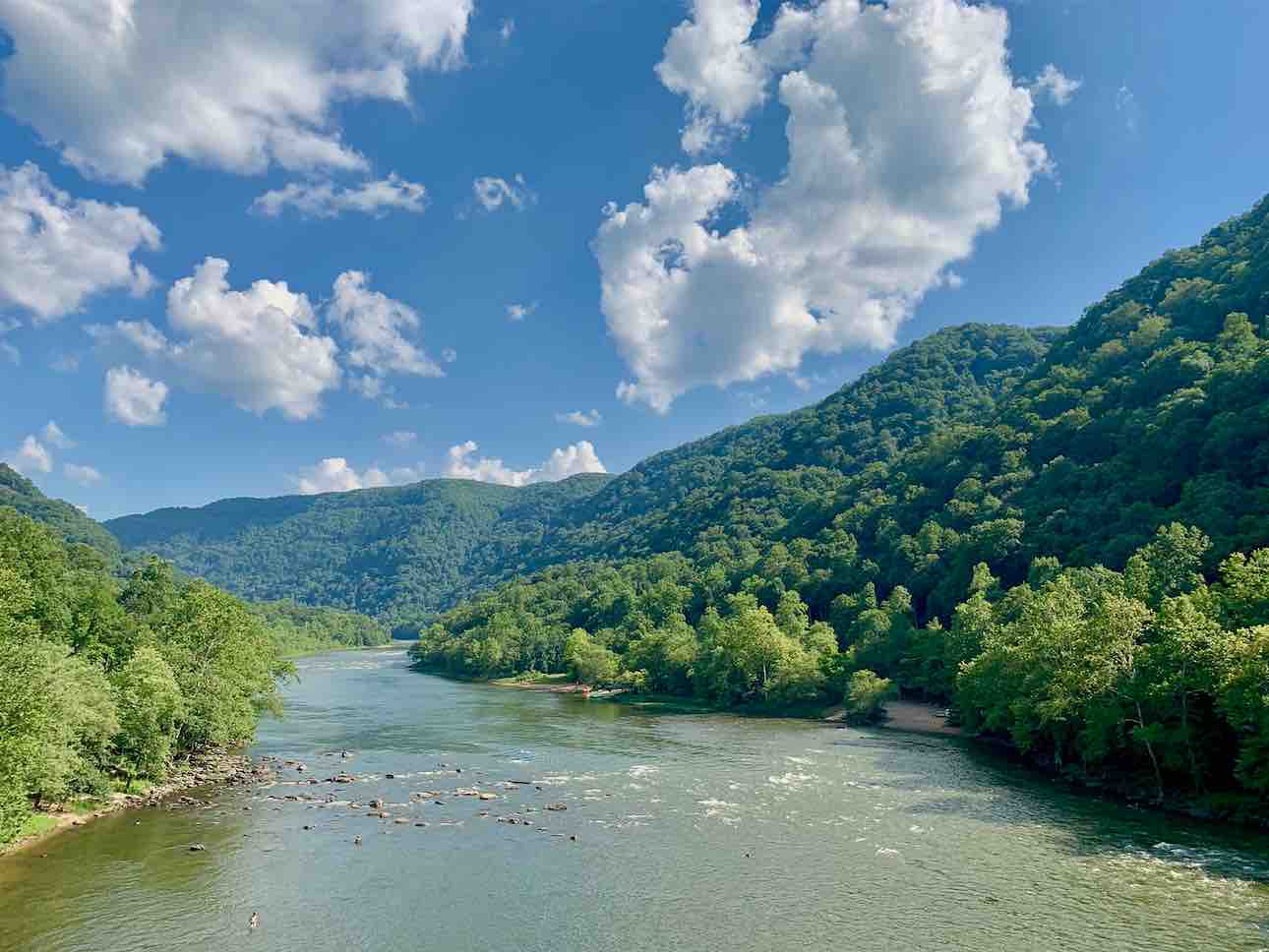 new river gorge at stonecliff river blue sky puffy clouds