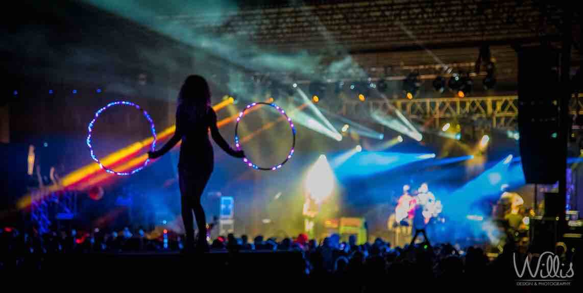girl in silloutte hula hooping in front of main stage at mountain music festival with umphreys mcgee