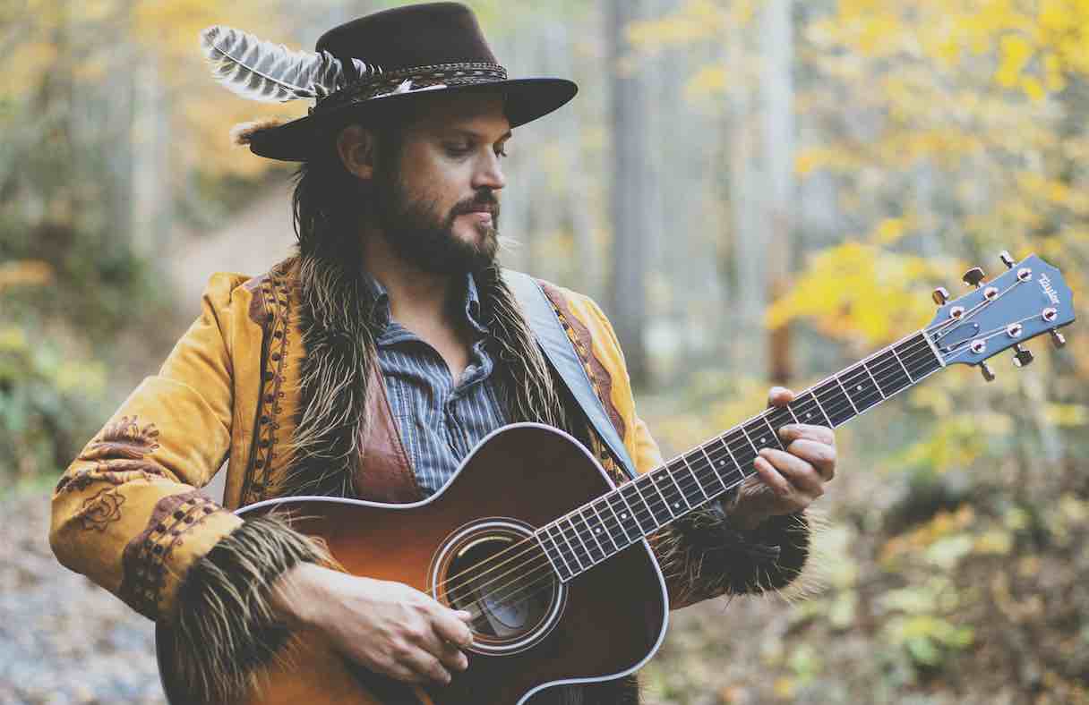 chance mccoy press photo playing guitar in the woods