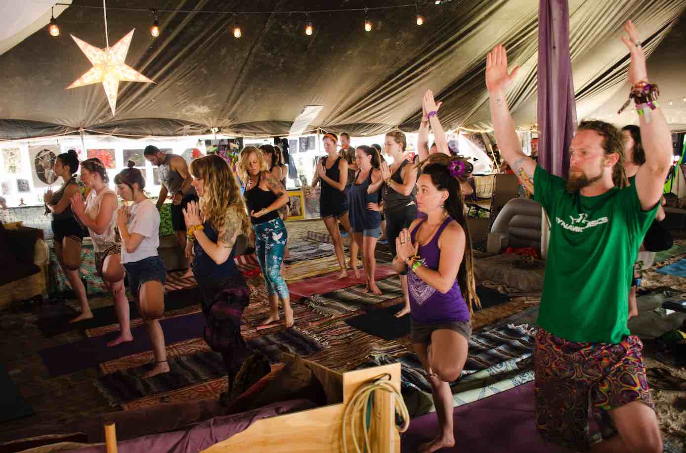 festival folks doing yoga 