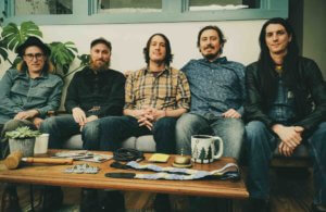 the freeway jubilee band photo sitting on couch around table