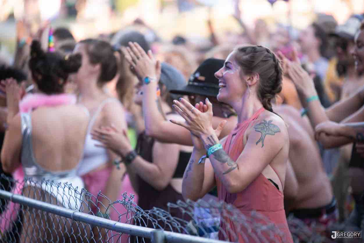 happy girl in the crowd at mountain music festival 2021