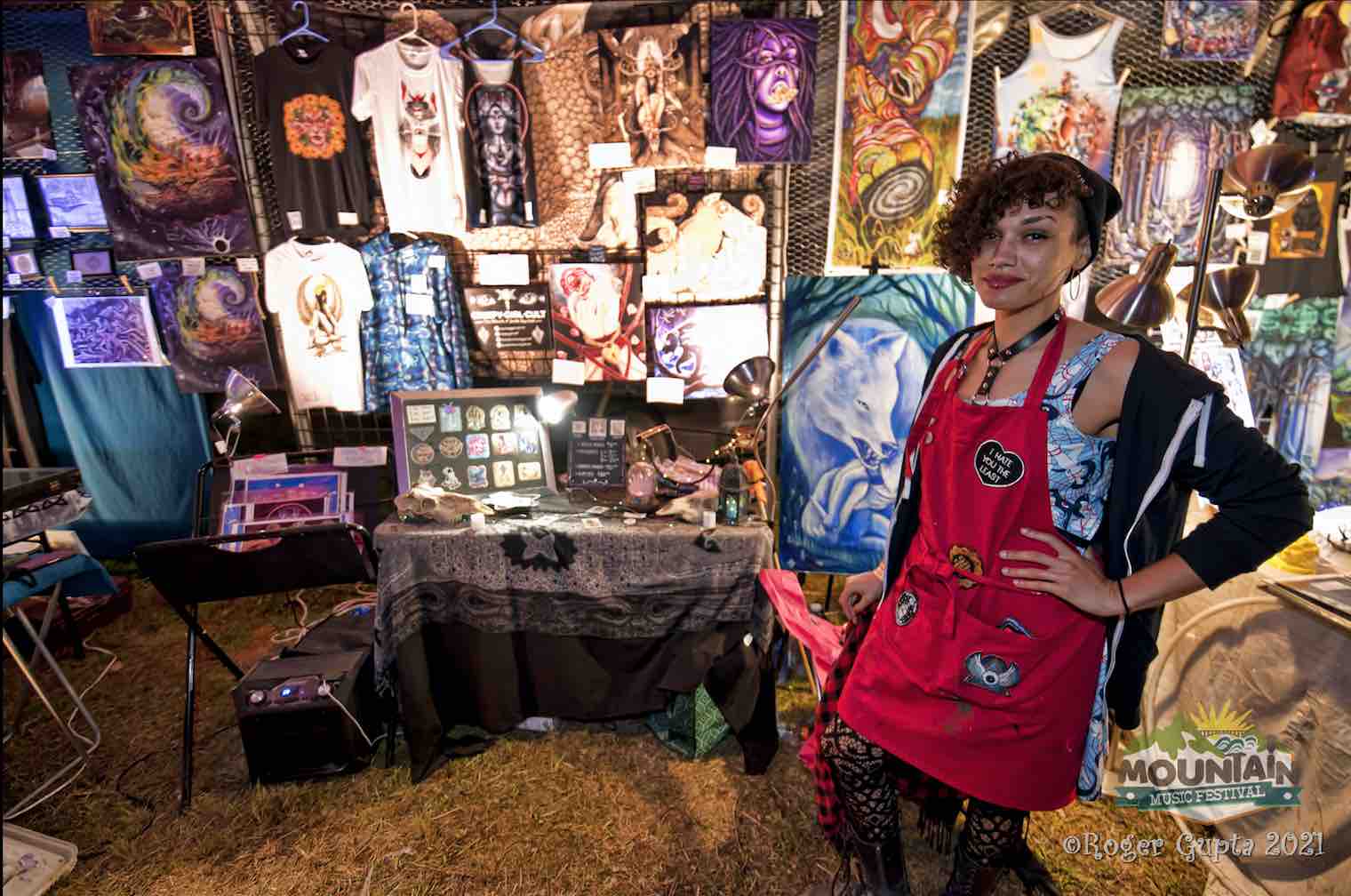 creepy cult girl at booth in pigment sanctuary art gallery mountain music festival