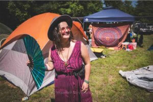 camping at mountain music festival girl with fan