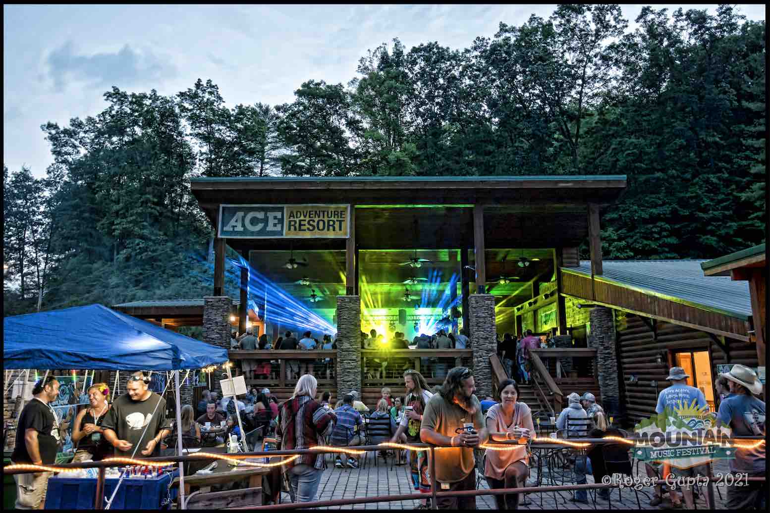 people on the patio of the lost paddle during mountain music festival pre party