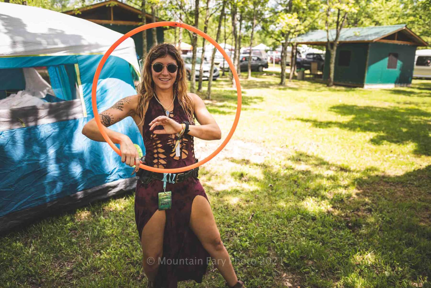 girl with hula hoop in the campground at mountain music festival 