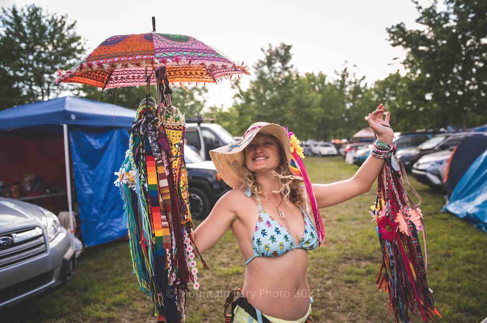 happy vendor girl in campground at mountain music festival