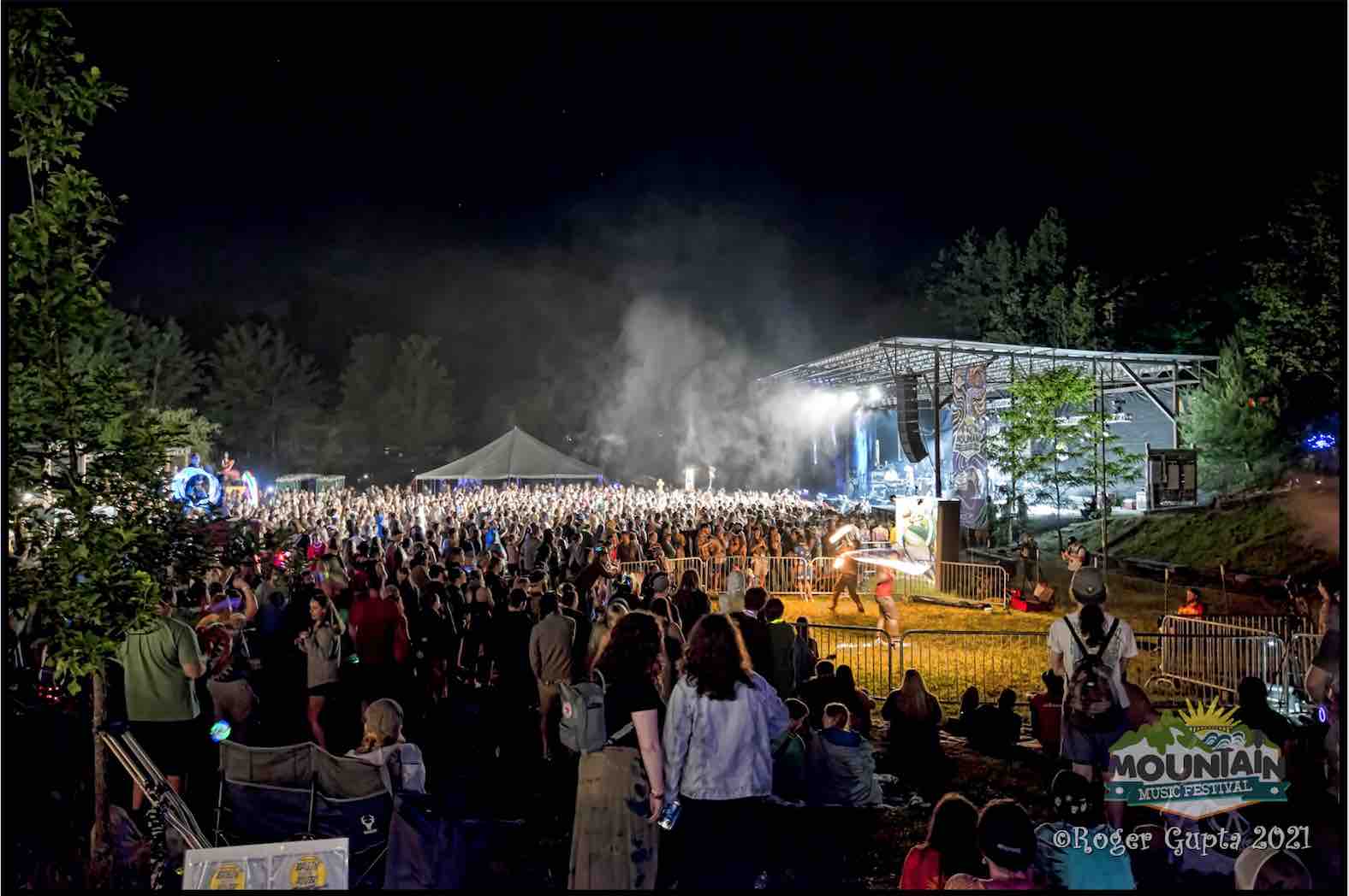 stage at mountain music festival 2021 with crowd and fire performers