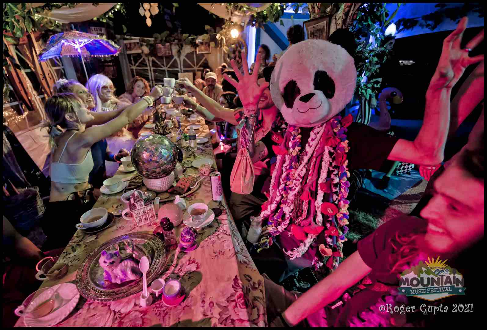 party people in the mad tea party at mountain music festival 2021 with panda mask