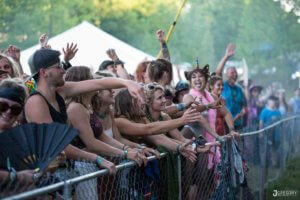 rail riders in front of stage at mountain music festival