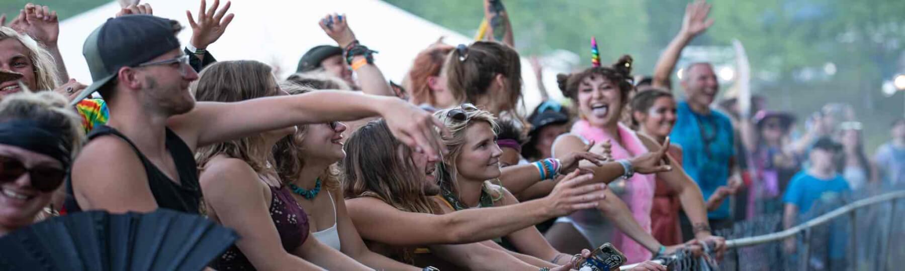 rail riders in front of stage at mountain music festival