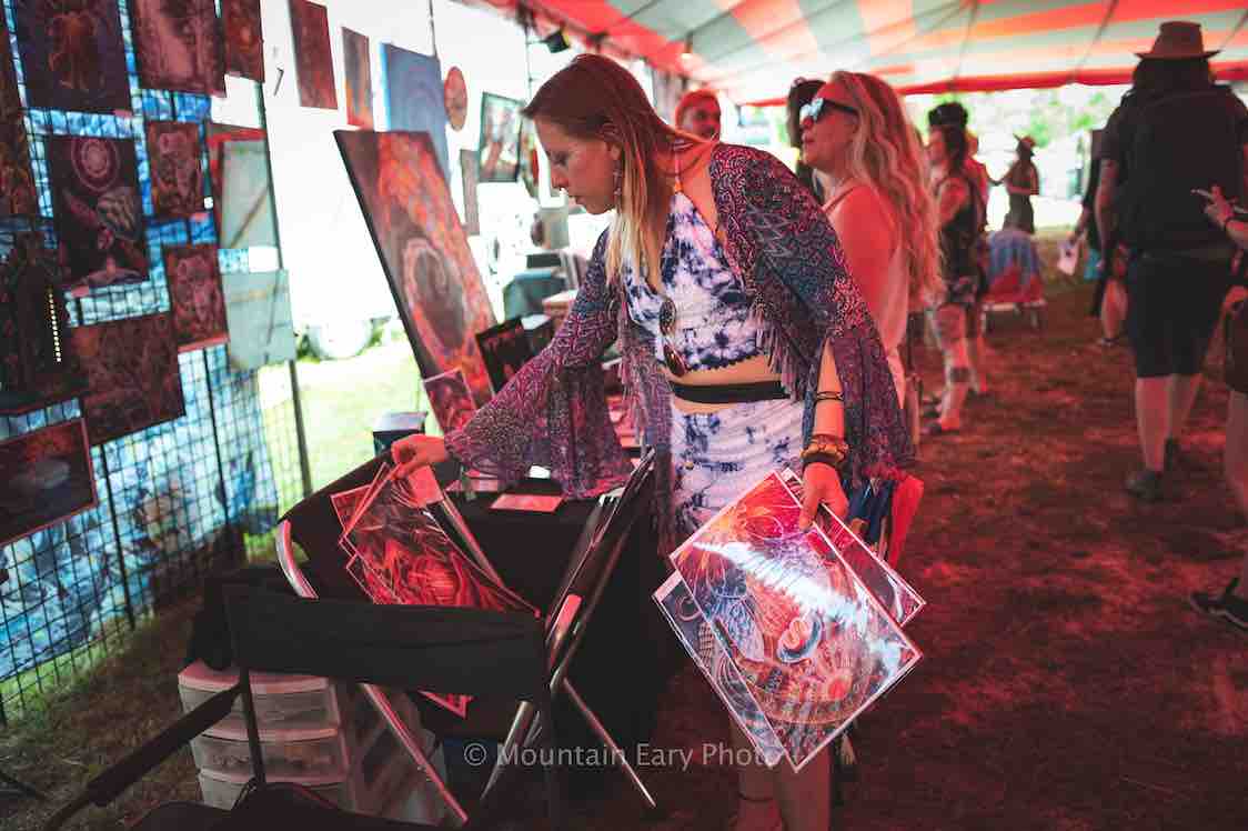 browsing art in the pigment sanctuary art gallery at mountain music festival